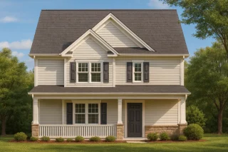 Front view of a Traditional Colonial style home featuring light siding, black shutters, a symmetrical façade, and stone-accented foundation.