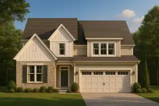 Front view of Modern Farmhouse home featuring board and batten siding, horizontal lap siding, stone base, and two-car garage under gabled rooflines