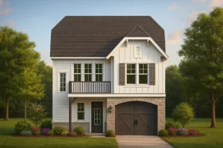 Front view of a Modern Farmhouse style home featuring board and batten siding, stone accents, and a one-car garage with dark wood doors.
